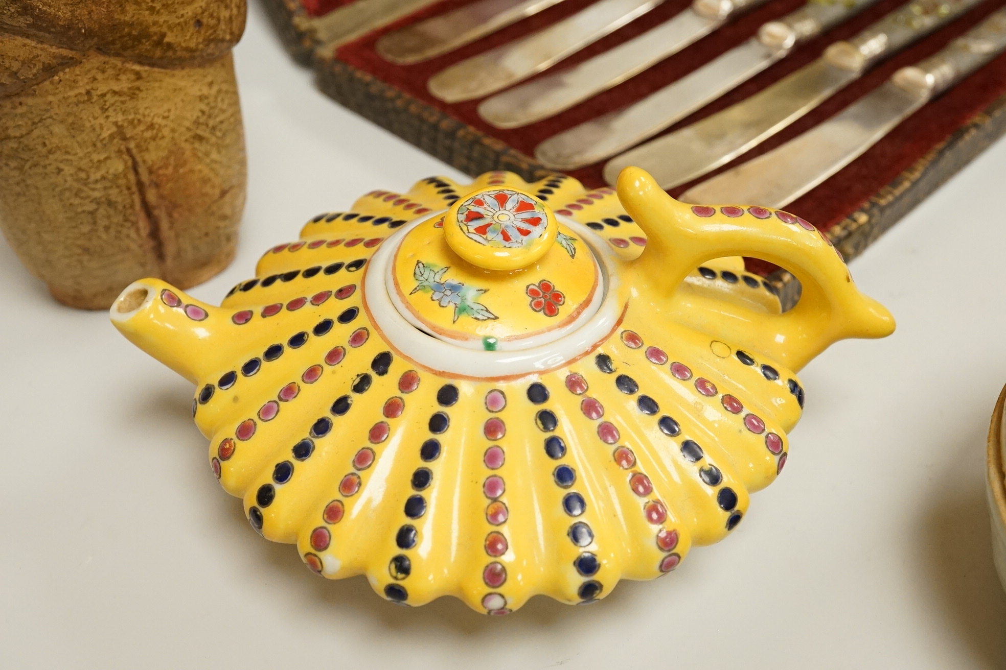 A cased set of semi-precious handled butter knives, two Chinese pottery teapots, a stoneware box and a figure, etc.